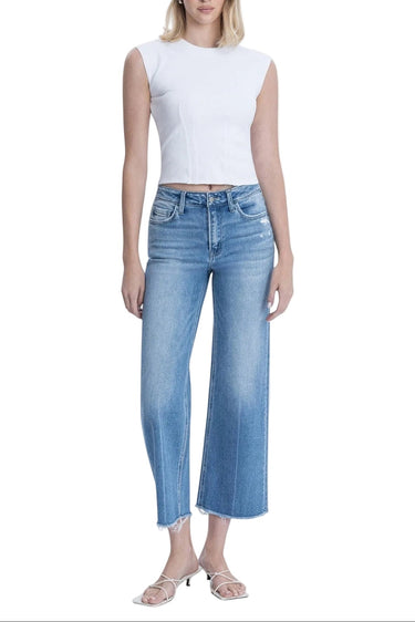 SaltTree medium wash high rise slim wide leg jeans with raw hem and distressed detailing. Model is 5'10" wearing size 3/26.