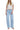 SaltTree light wash denim jeans with a super high rise, long barrel leg, and finished hem. Model wears size 3/26.