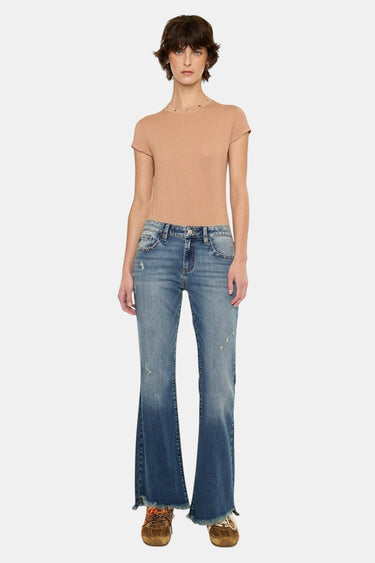 SaltTree dark wash low rise ankle flare jeans with uneven frayed hem and distressed details. Model is wearing size 5/26.