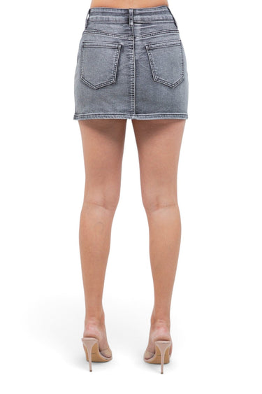 SaltTree American Bazi black wash denim mini skirt with back pockets, worn by a model with beige heeled sandals.