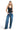 SaltTree model wearing ANWND black ribbed tank bodysuit with a plunging V-slit neckline and wide-leg blue jeans