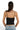 Back view of a model wearing a black SaltTree ANWND ribbed cropped camisole with adjustable spaghetti straps.