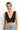 SaltTree ANWND black ribbed sleeveless crop top with deep V-neckline worn by a smiling model