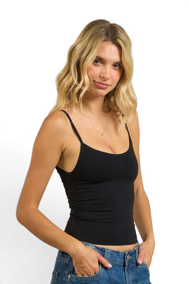 SaltTree model wearing a black ANWND seamless cami top with spaghetti straps and a shirred bust detail.