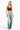 SaltTree model wearing a brown ANWND ribbed crop cami with lace trim and adjustable straps paired with wide-leg jeans