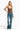 Model wearing a brown SaltTree ANWND sweetheart neckline bodysuit with adjustable straps and blue denim jeans