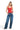 Model wearing a red SaltTree ANWND square neck sleeveless bodysuit tucked into wide-leg blue jeans