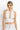 SaltTree ANWND white halter crop top with deep V-neck, shirred bust, and ribbed wide waistband on a model