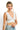 SaltTree ANWND white ribbed sleeveless crop top with a deep V-neckline worn by a smiling model.