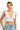SaltTree ANWND white ribbed sleeveless crop top with a deep V-neckline worn by a model with light blonde hair.