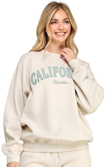 SaltTree model wearing a beige oversized fleece sweatshirt with California Republic embroidery and crew neckline