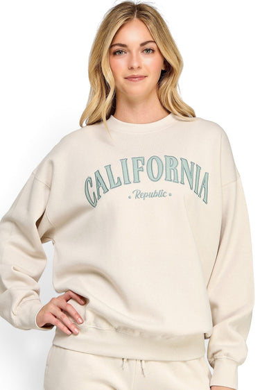 SaltTree model wearing a beige oversized fleece sweatshirt with California Republic embroidery and crew neckline