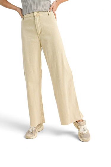 SaltTree high-rise wide-leg crop pants in beige stretch twill with a raw hem, worn with sneakers.