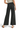 SaltTree high rise black wide leg crop pants with a raw hem, worn by a model from the back view.