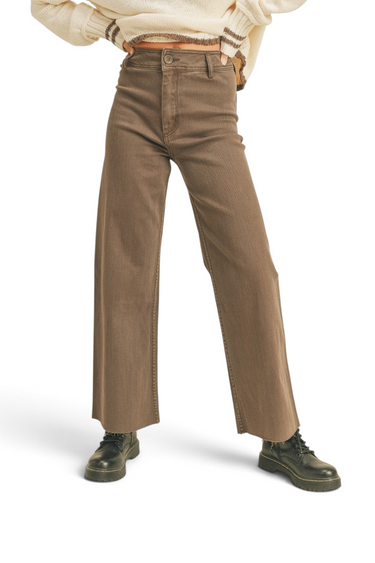SaltTree high-rise brown stretch twill wide-leg pants with a raw hem, worn by a model in a cream sweater.
