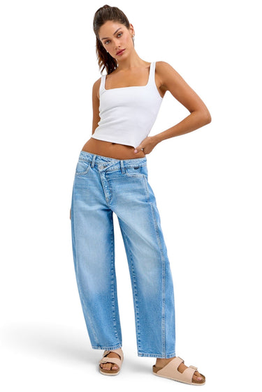 SaltTree model wearing Cello Jeans light wash mid-rise barrel leg denim with an asymmetric front closure