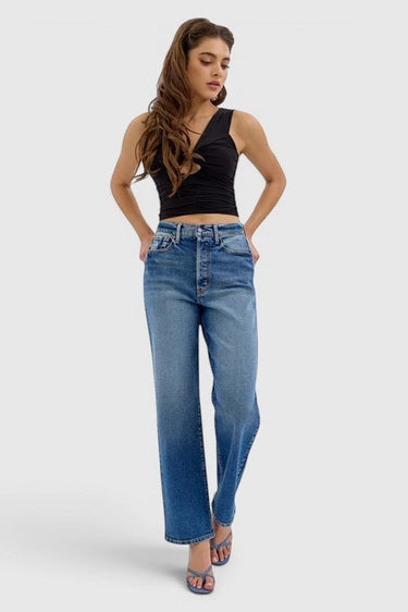 SaltTree model wearing Cello Jeans super high rise medium wash dad jeans with a relaxed straight leg fit.