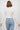 SaltTree Dreamers off-white long sleeve cropped ribbed cardigan with scalloped edges worn by a model with light jeans.