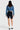 SaltTree Enjean cropped denim jacket in medium wash worn by a model with black biker shorts and a baseball cap
