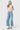 Model wearing SaltTree Flying Monkey medium wash high rise wide leg cropped jeans with a drawstring waist tie.