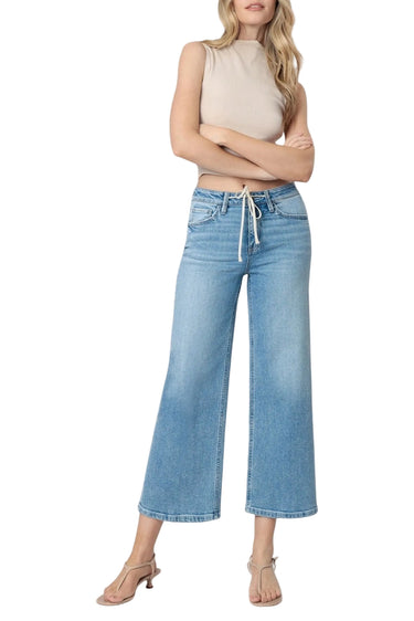 Model wearing SaltTree Flying Monkey medium wash high-rise drawstring wide-leg cropped jeans with a trouser crease.