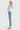 Model wearing SaltTree Flying Monkey high rise medium wash kick flare jeans with a trouser slit hem from the side.