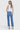 Model wearing SaltTree Flying Monkey medium dark wash high rise ankle straight jeans with distressed back hem