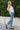 SaltTree model wearing Flying Monkey medium wash high rise kick flare jeans with a trouser slit hem and white top