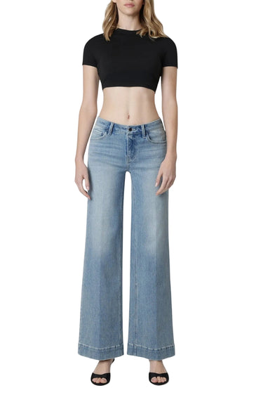 Model wearing SaltTree Flying Monkey mid rise wide leg jeans in light wash with a trouser crease and 32 inch inseam.