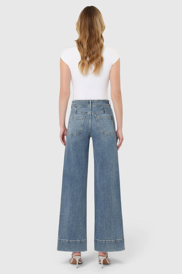 SaltTree Flying Monkey medium wash high rise wide leg jeans with half yoke back detail on a model from behind.