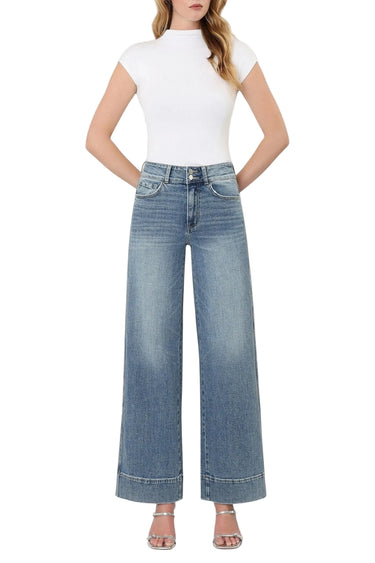 Model wearing SaltTree Flying Monkey medium wash super high rise wide leg jeans with a trouser hem and 2-button waist.