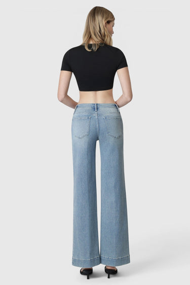 SaltTree Flying Monkey mid rise wide leg jeans in light wash denim with trouser hem, back view on a model.