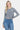 SaltTree model wearing a grey slim-fit cropped button-up cardigan by Dreamers with long sleeves and blue jeans.