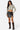 SaltTree Love Poem black faux leather A-line mini skort with front slit worn by a model with a cropped zip-up top.