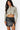 SaltTree Love Poem black faux leather A-line mini skort with front slit worn by a model in a cropped zip-up top