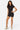 SaltTree Love Poem black fitted polo romper with front zip closure worn by a model in sneakers