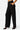 SaltTree Love Poem black high-rise wide-leg scuba knit pants with a belted waist and pockets worn by a model.