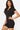 SaltTree Love Poem black fitted polo romper with a front zip closure and short legs on a model