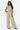 Model wearing SaltTree Love Poem off-white crinkled plisse crop top and wide-leg pants with rhinestone details.