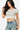 SaltTree Love Poem white double-layered contour cropped crew neck t-shirt worn by a model with blue denim jeans