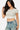 SaltTree Love Poem white double-layered contour cropped crew neck t-shirt worn by a model with blue denim jeans