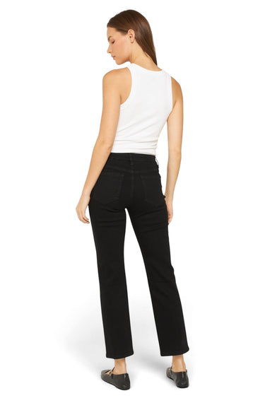 SaltTree model wearing Mica Denim solid black mid-rise ankle straight jeans with a white tank top, back view.