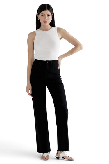 SaltTree Mica Denim high-rise slim wide-leg black jeans with a raw hem worn by a model in a white tank top