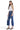 SaltTree model wearing Mica Denim high-rise medium blue vintage distressed crop flare jeans with raw frayed hems.