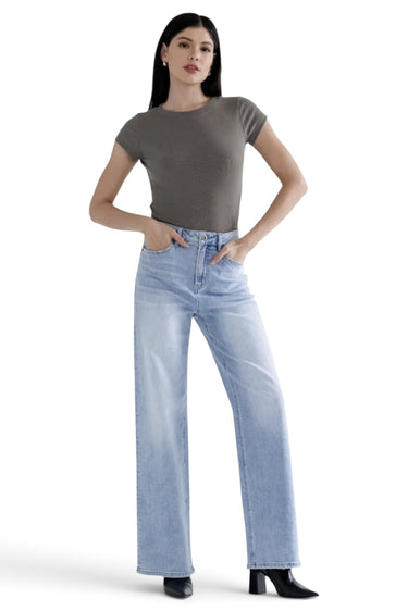 Model wearing SaltTree Mica Denim super high rise loose straight jeans in light blue wash with a grey t-shirt.