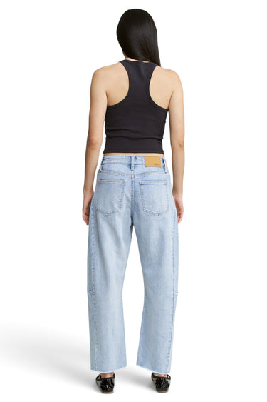 SaltTree Mica Denim light wash barrel leg jeans with curved seams and raw hem, viewed from the back on a model.