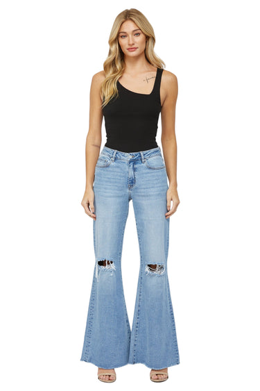 SaltTree Mica Denim light wash high rise super wide leg jeans with distressed knees and raw frayed hem on a model
