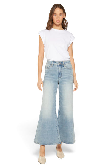 SaltTree model wearing Mica Denim high rise super wide palazzo crop jeans in a medium wash with a white t-shirt