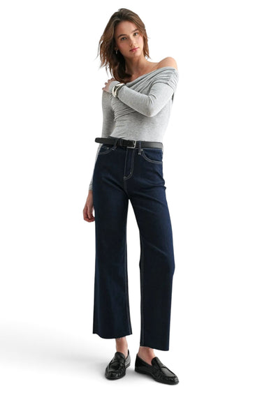 SaltTree model wearing Mica Denim dark indigo high-rise wide-leg ankle jeans with shimmer finish and raw-cut hem.