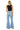 Model wearing SaltTree Mica Denim high rise super wide leg jeans in light wash with a raw frayed hem from behind